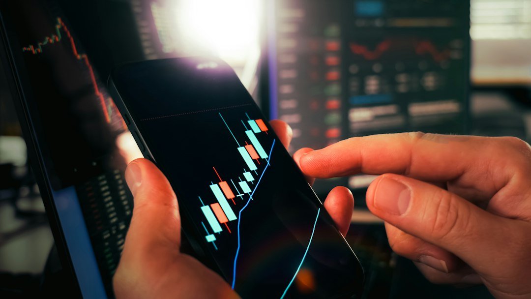 Hands reviewing a stock chart on a smartphone